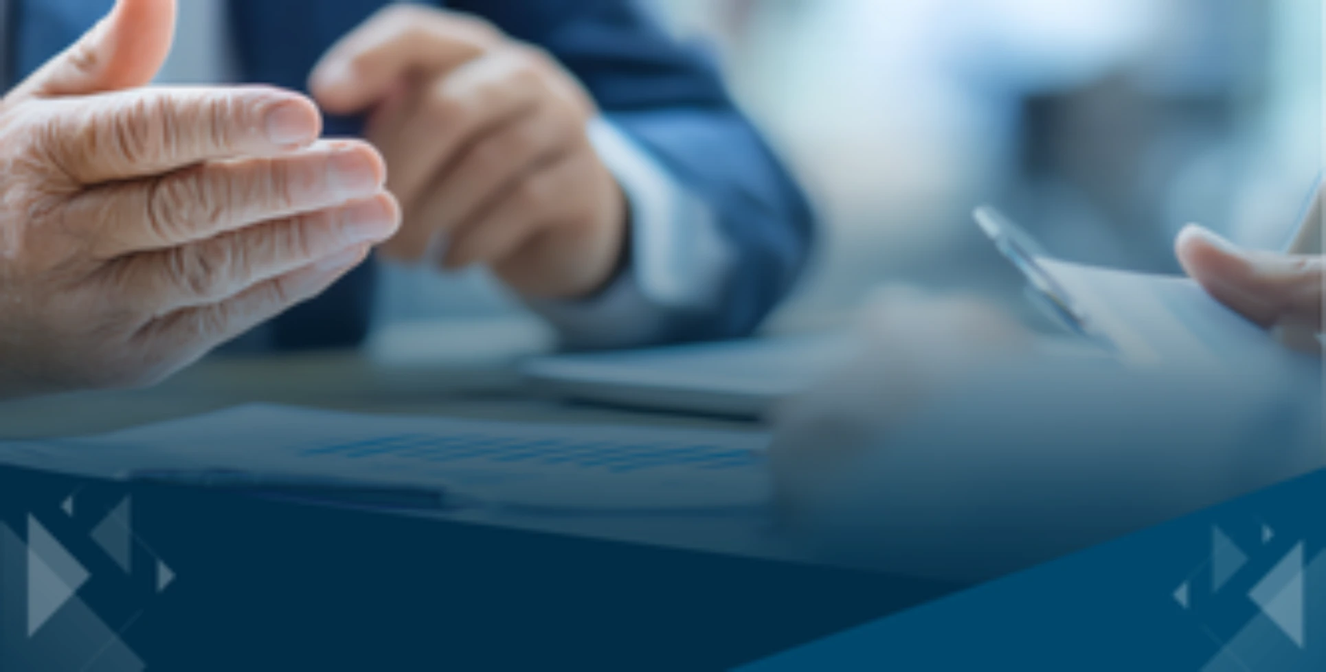 Close-up of business professionals discussing documents during a planning meeting